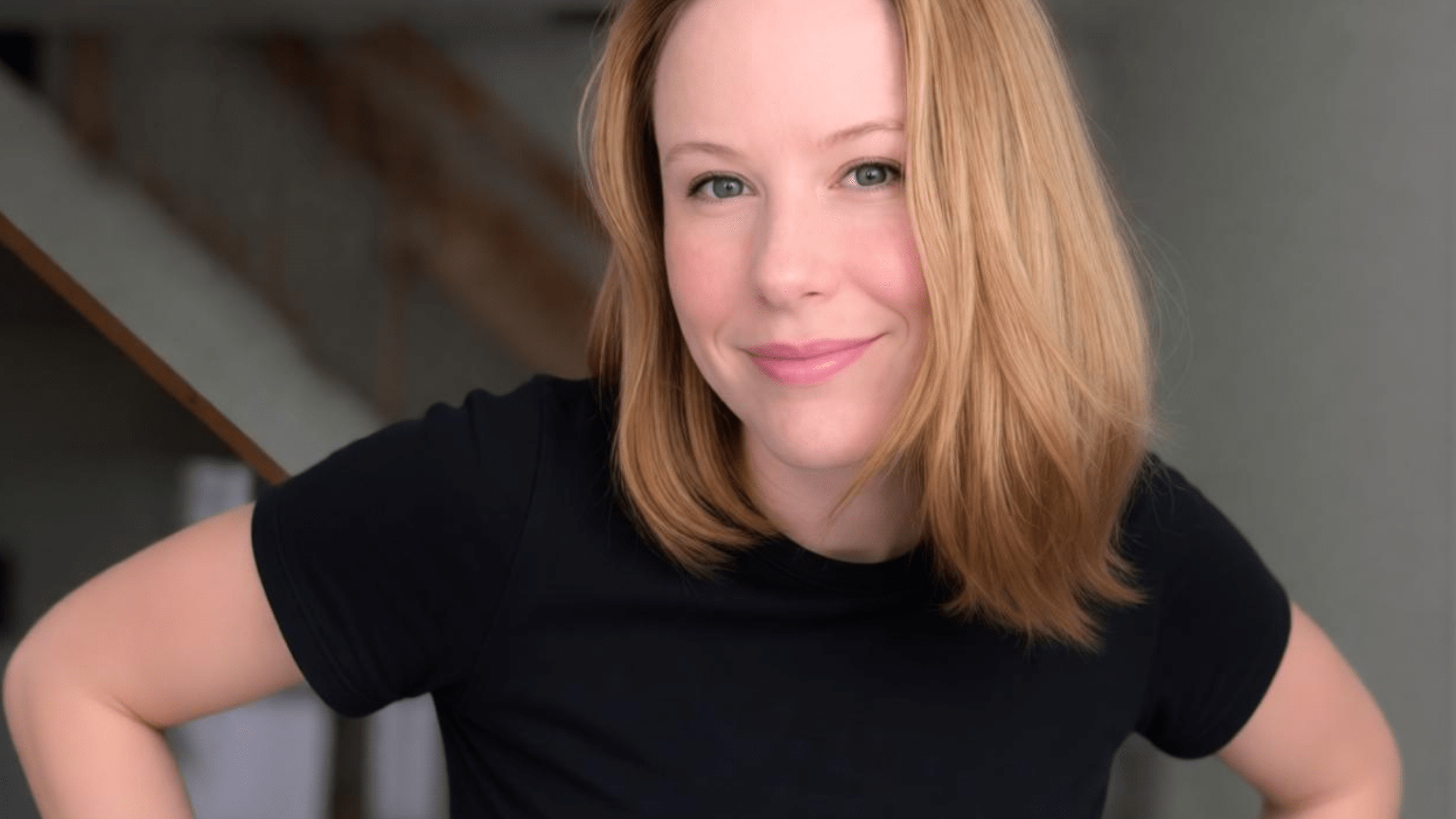 Hannah O'Neill hands on hips with black t-shirt
